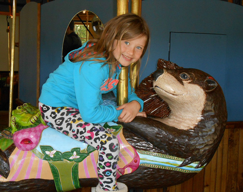 Oliver the Otter with girl riding